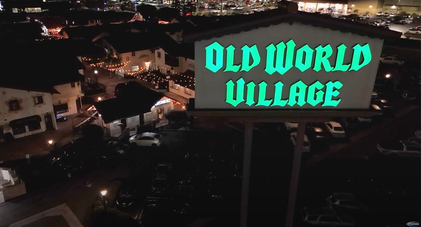 The Old World Village Sign at Night
